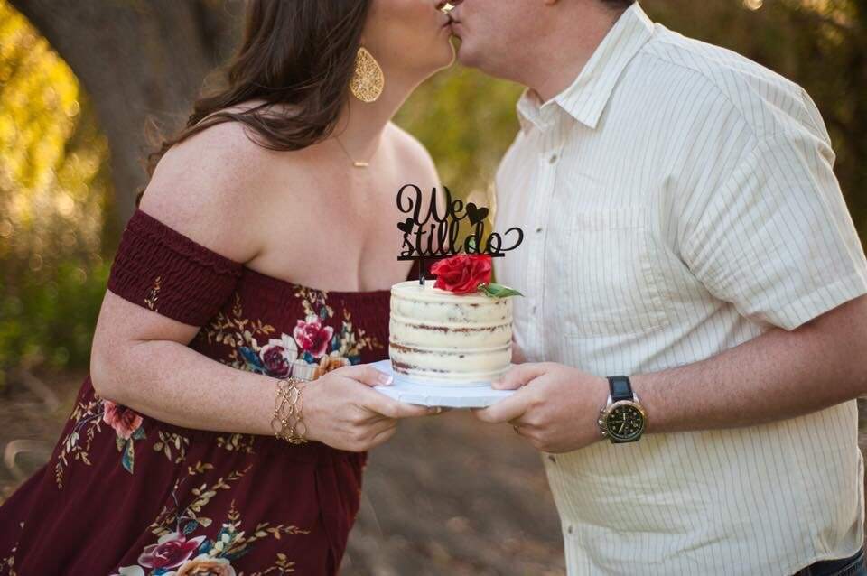 couple holding wedding cake